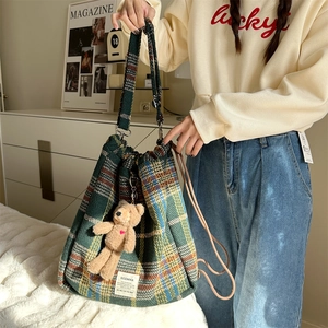 Green plaid wool bucket backpack with drawstring closure and cute bear charm