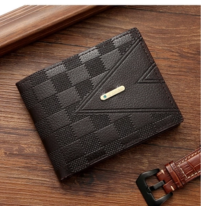 Close-up of deep brown leather wallet with checkered V-embossing on wood background