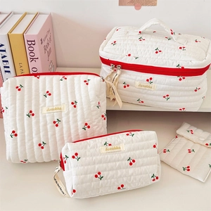 Quilted cotton cherry print makeup bag set showing four different storage sizes