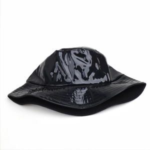 Detail of glossy black faux leather bucket hat with a modern minimalist shiny finish