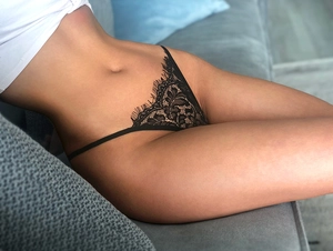 Detailed view of sexy black floral lace thong with eyelash trim and delicate side straps