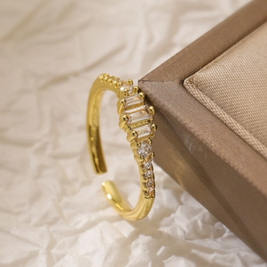 Minimalist 18K gold plated ring featuring three baguette-cut cubic zirconia crystals