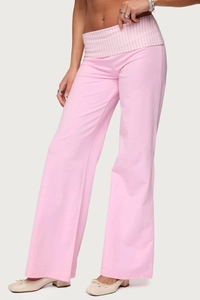 Detail of pink flare pants featuring high waist pink and white striped fold-over waistband