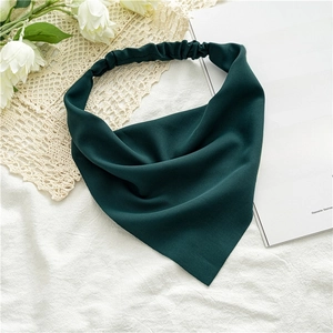 Detail of dark green chiffon headscarf with elastic band on floral background