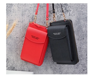 Detail of red and black crossbody phone wallets with gold hardware and snap closures