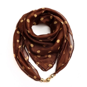 Close-up of brown chiffon polka dot scarf with a decorative golden magnetic buckle detail