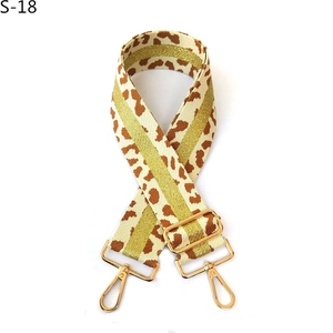 Detail of adjustable beige leopard print strap with gold glitter stripes and metal hooks