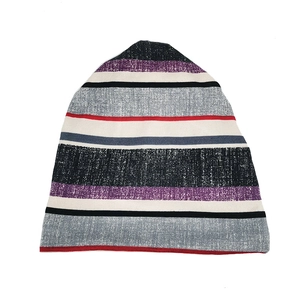 Close-up of multi-colored striped knit beanie with purple, grey and red horizontal patterns