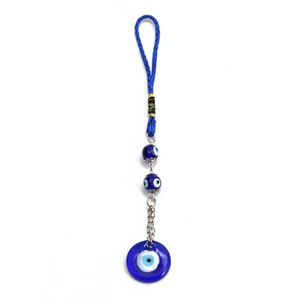 Detail of blue evil eye keychain with woven ring and glass pendant on a white background