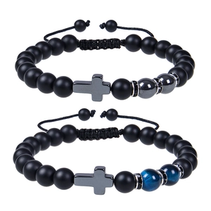 Detail of 8mm matte black stone beaded bracelets with metal crosses and adjustable ropes