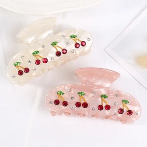 Detail of cream and pink cherry hair claws with rhinestones and acrylic finish