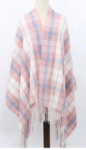 Detail view of pink and blue plaid scarf with soft tassels on a white background