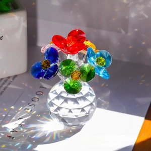 Macro detail of faceted crystal flowers with colorful petals on clear glass bases