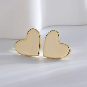 Elegant gold heart stud earrings for women with a minimalist polished metal finish