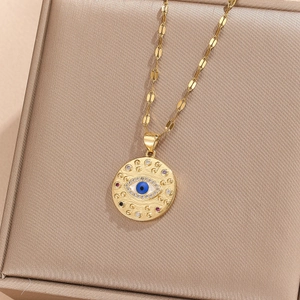 Detailed close-up of golden evil eye pendant necklace with colorful cubic zirconia