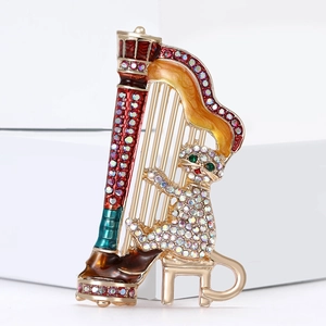 Creative enamel cat playing harp brooch with crystal rhinestones on white pedestal