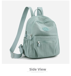 Side view detail of a light mint green nylon backpack with soft texture and adjustable straps