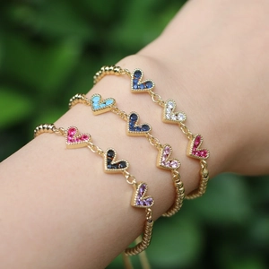 Adjustable golden heart bracelet featuring vibrant multi-color cubic zirconia inlay