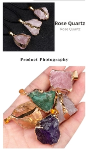 Macro detail of natural raw crystal pendants with gold-plated edges in various colors