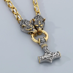 Close-up of Viking Mjölnir pendant with wolf heads on a bicolor stainless steel chain