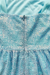 Detail of light blue sequin dress featuring a high-quality invisible back zipper closure