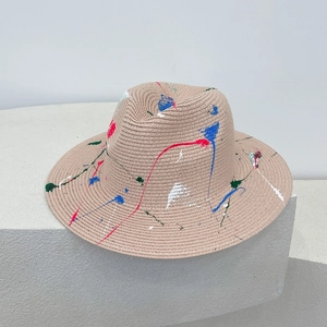 Light khaki straw Panama hat featuring colorful graffiti paint splatters for summer