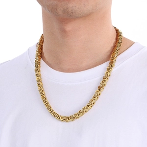 Close-up of gold Byzantine weave chain necklace on male model showing thick metal texture