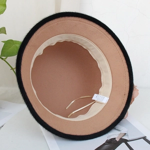 Detail showing the inner lining and material label of the 20% wool camel felt hat