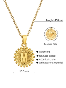 Detail of 18K gold-plated stainless steel M-letter pendant showing back heart embossing