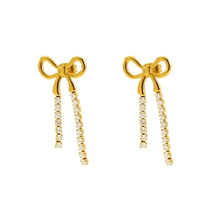 Detailed close-up of gold bow earrings with crystal-encrusted long tassels on white background