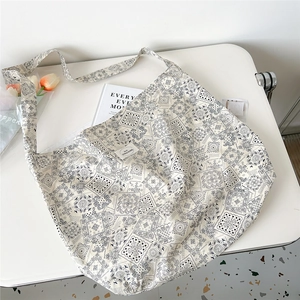 Detail of floral canvas tote bag with paisley pattern and vintage artistic style
