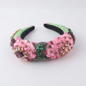 Detail of pink floral sequins and large purple crystals on wide sponge headband