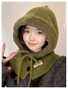 Detail of green knit balaclava with warm lamb wool lining, buttons and drawstring