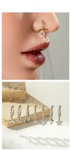 Detailed view of copper zircon nose rings in heart, star, and flower shapes with gold finish
