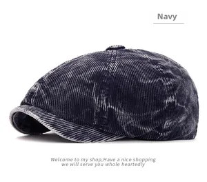 Detail view of the navy corduroy newsboy cap showing the textured ribbed fabric