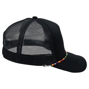 Detail view of black mesh trucker hat featuring a vibrant colorful beaded chain accessory