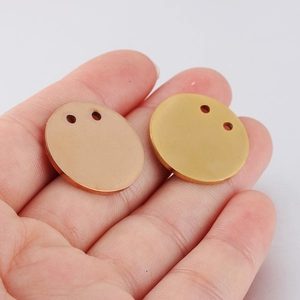 Detail of 21mm rose gold and gold stainless steel pendants with double holes and mirror finish