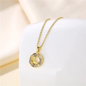 Macro view of 18K gold stainless steel necklace with round 'L' letter zircon pendant