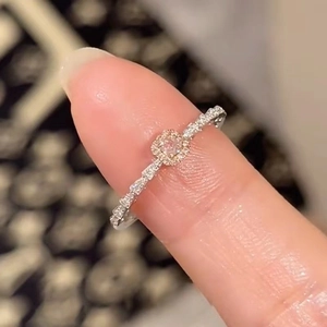 Macro shot of an elegant pink princess cut ring with a sparkling halo and diamond-set band