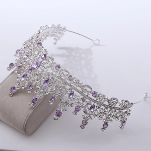 Luxury silver bridal crown featuring purple amethysts and sparkling rhinestones for weddings