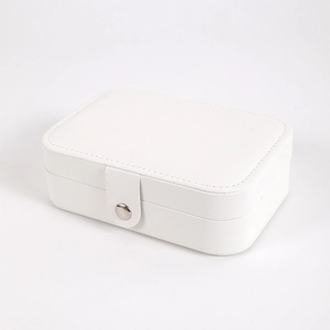 Close-up of white PU leather jewelry box featuring a secure metal snap fastener