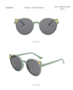 Detail of green cat-ear kids sunglasses with black lenses and golden metal accents