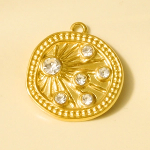 Detailed view of an 18k gold-plated irregular pendant with sunburst engraving and zircons