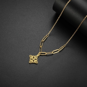 Close-up of gold stainless steel witch knot necklace with mixed paperclip and cross chains