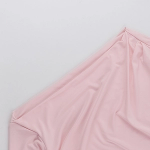 Detail shot of pink long sleeve top showing the soft fabric texture and stitching quality