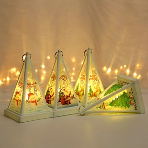 Detailed view of pyramid Christmas lanterns featuring Santa and reindeer with warm LED light
