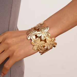 Detailed view of golden double-layer flower cuff bracelet with metallic petal texture