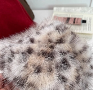 Detailed close-up showing soft leopard print faux fur texture with high-quality fibers