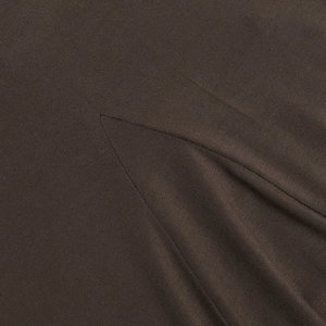Macro detail of dark brown knit fabric texture and high-quality stitching on the dress