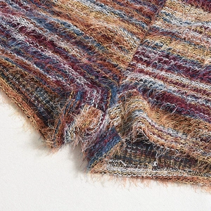 Macro view of multi-colored woven fabric detail with fringe for two-piece clothing set